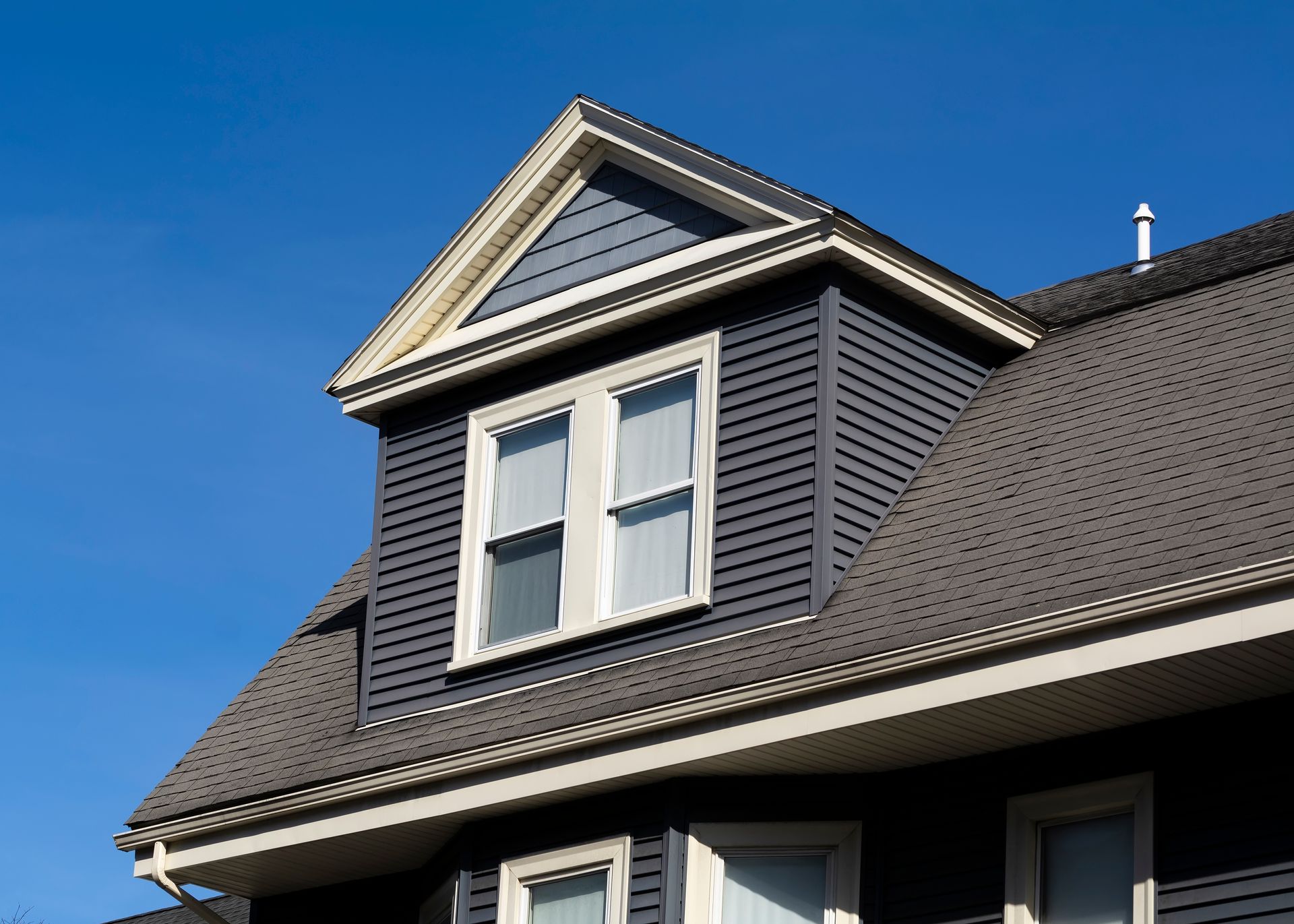 Dark blue house with a dormer