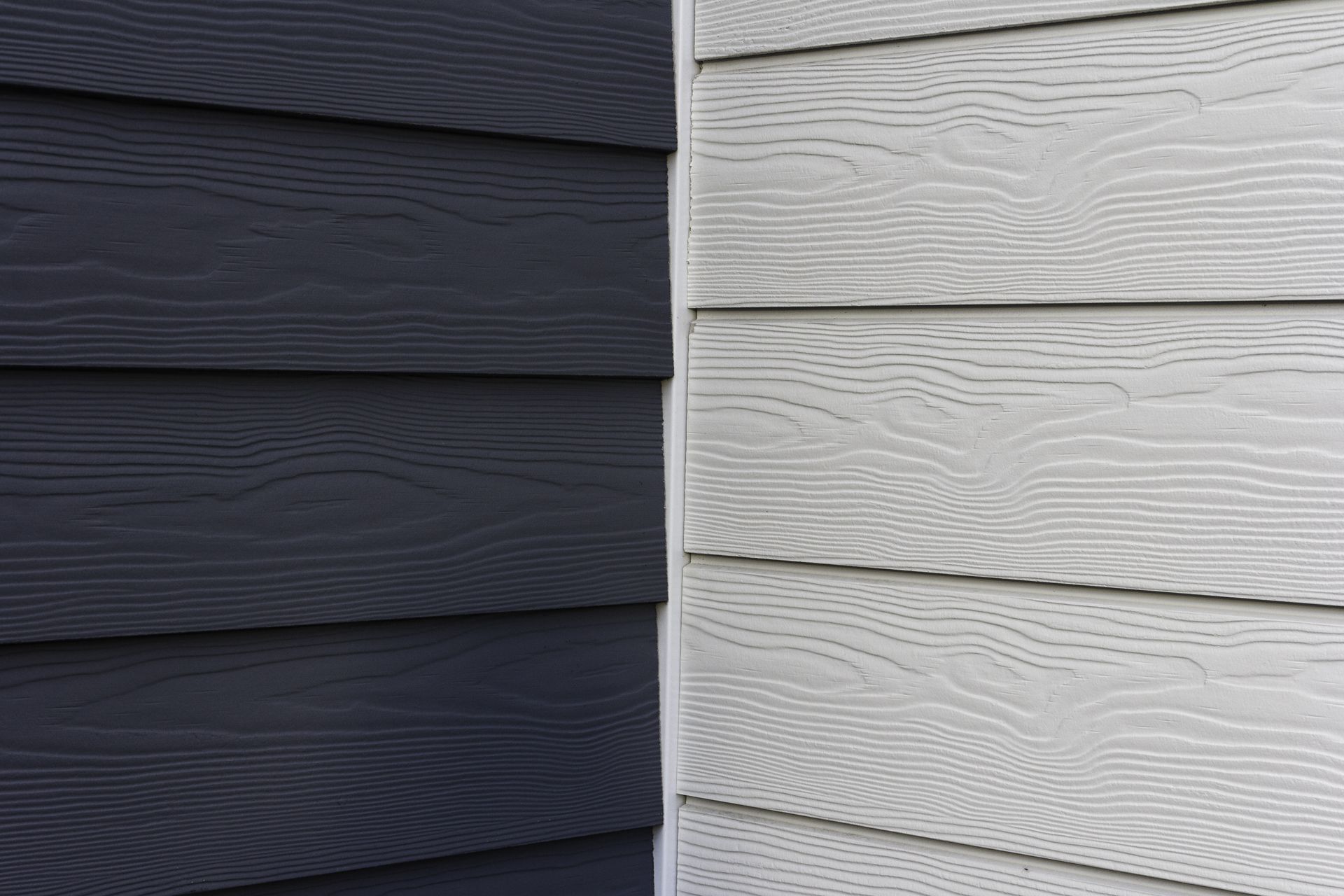Dark gray and white siding on the corner of a building