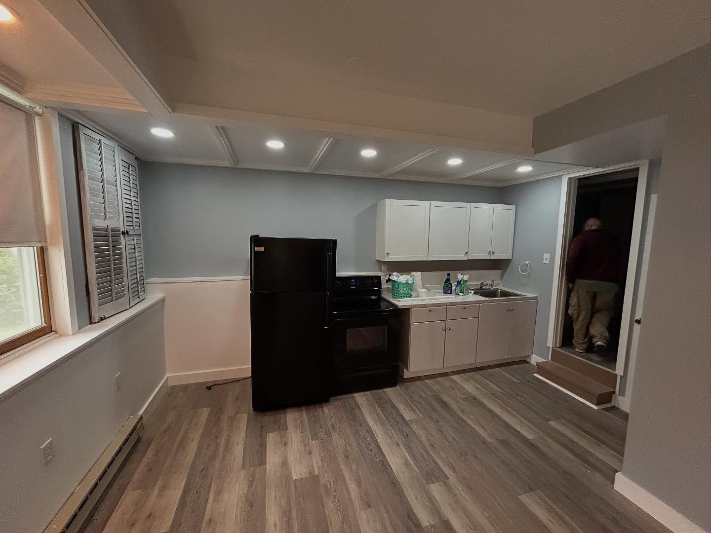 A wooden fence is sitting on top of a lush green field.
