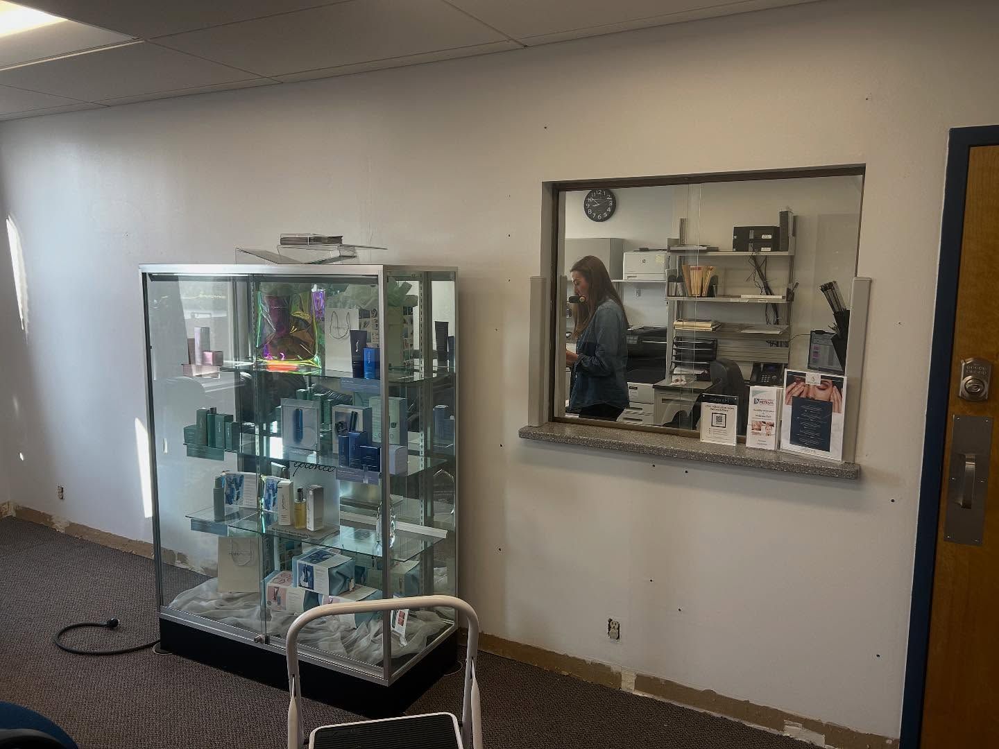 Display case next to a service window with a person inside.