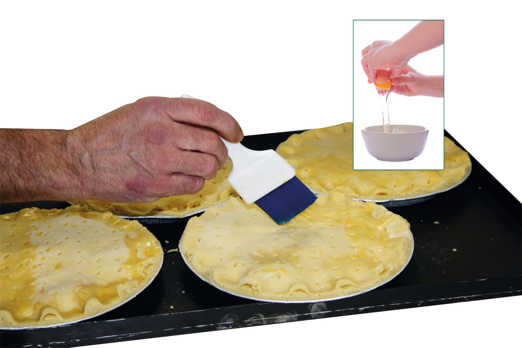 A person is brushing a pie with a brush