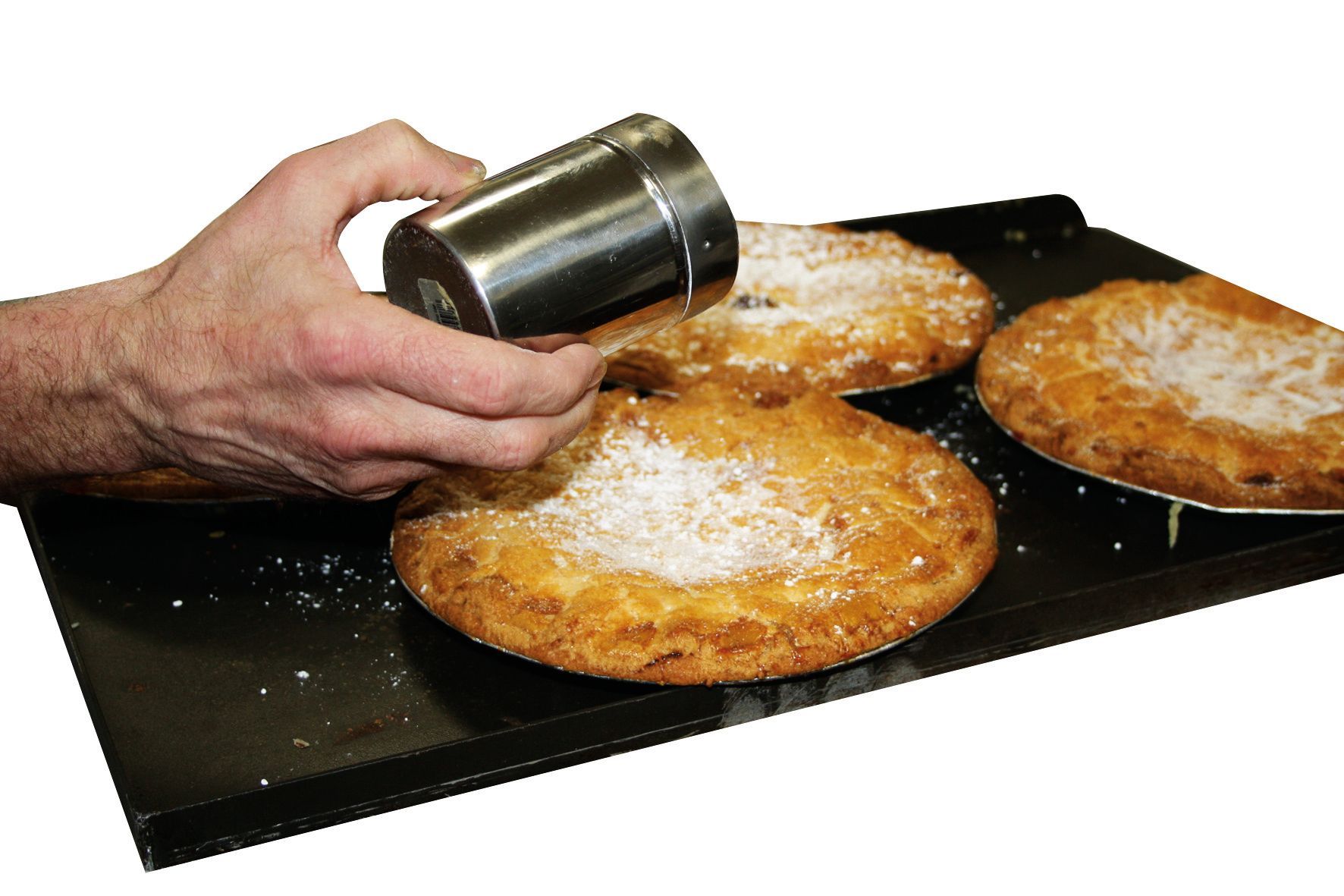 A person is sprinkling powdered sugar on a pie