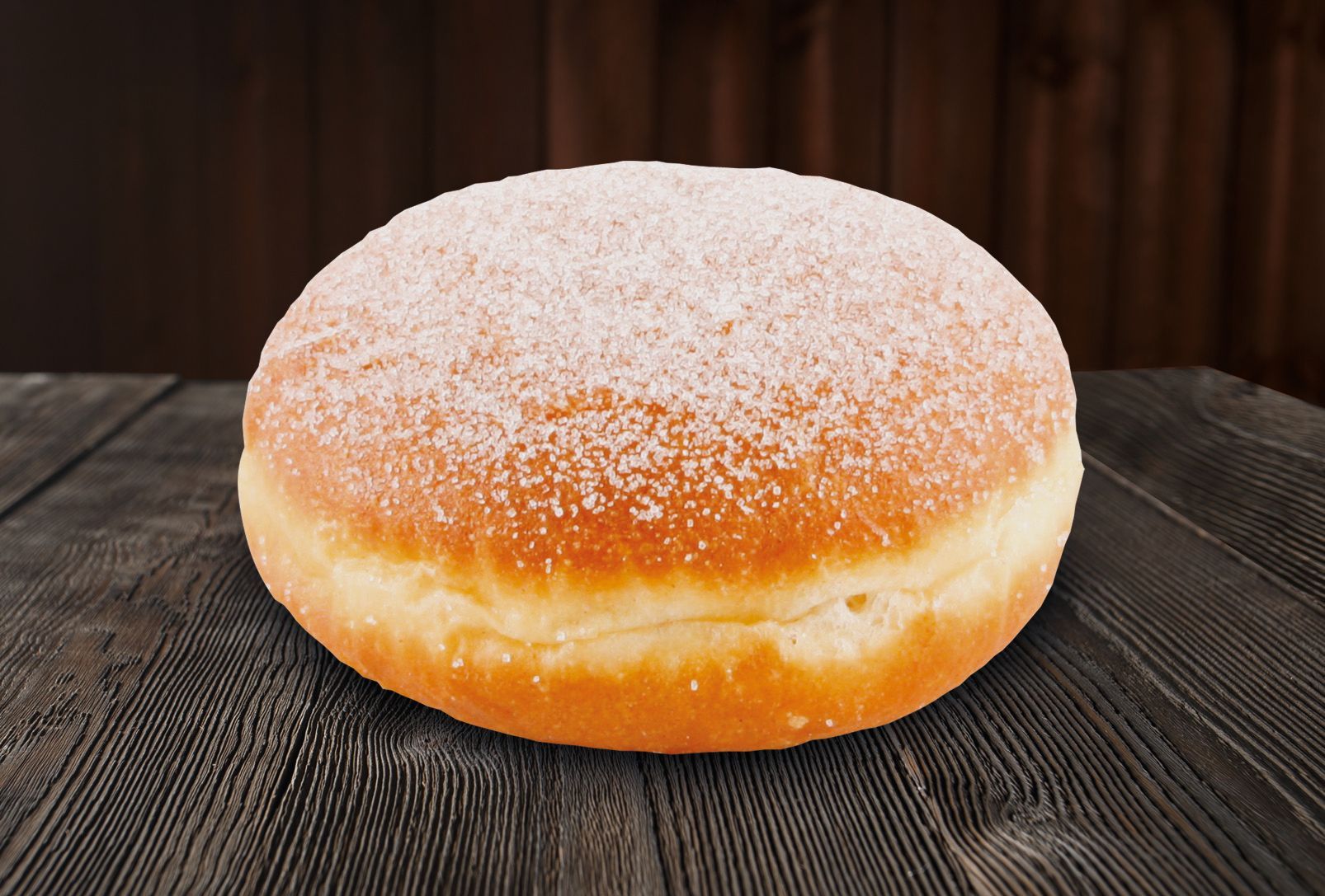 A donut with powdered sugar on top is sitting on a wooden table.