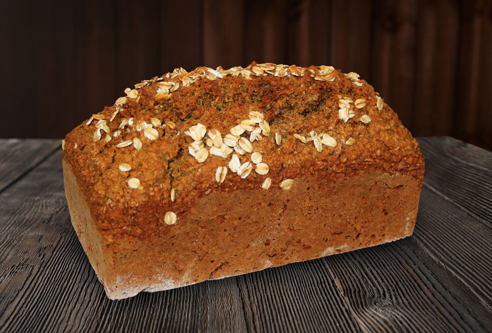 A loaf of bread is sitting on a wooden table.