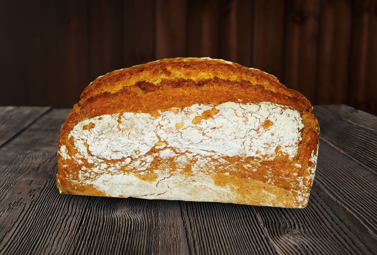 A loaf of bread is sitting on a wooden table.