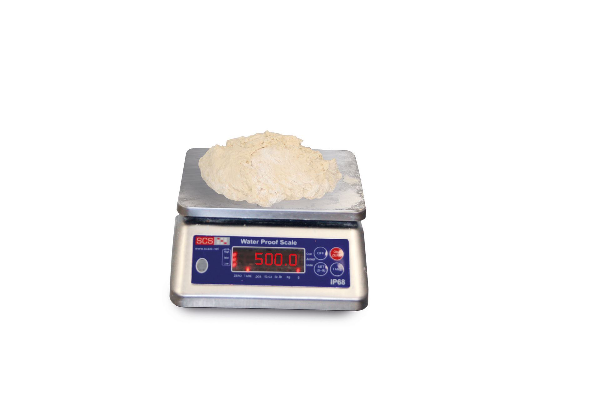 A digital scale with a pile of rice on top of it.