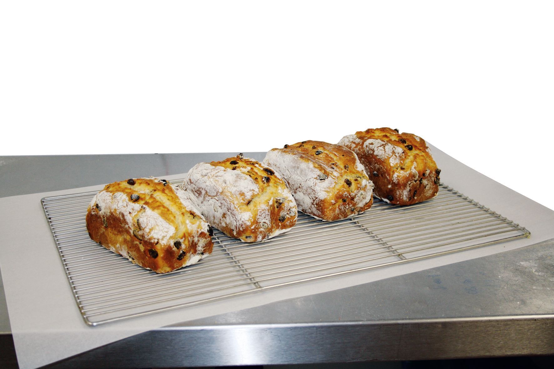 Four pastries are sitting on a wire rack on a table