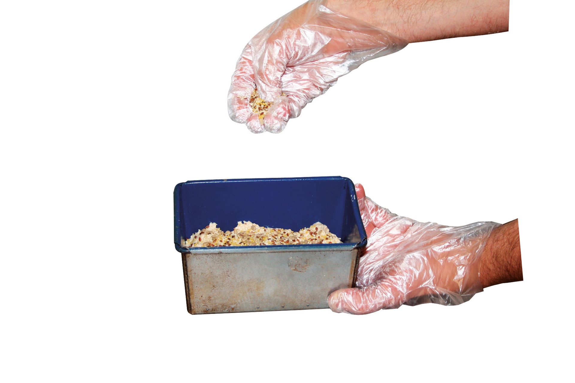 A person wearing plastic gloves is pouring food into a container