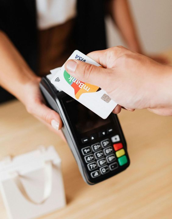 A person is using a credit card to pay for something.