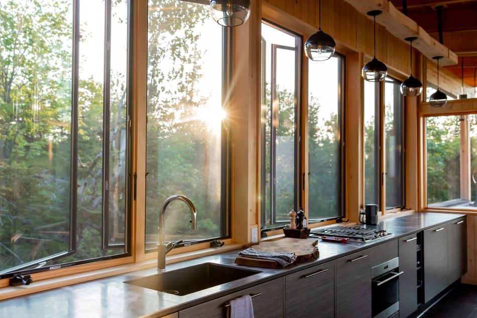 A kitchen with lots of windows and a sink
