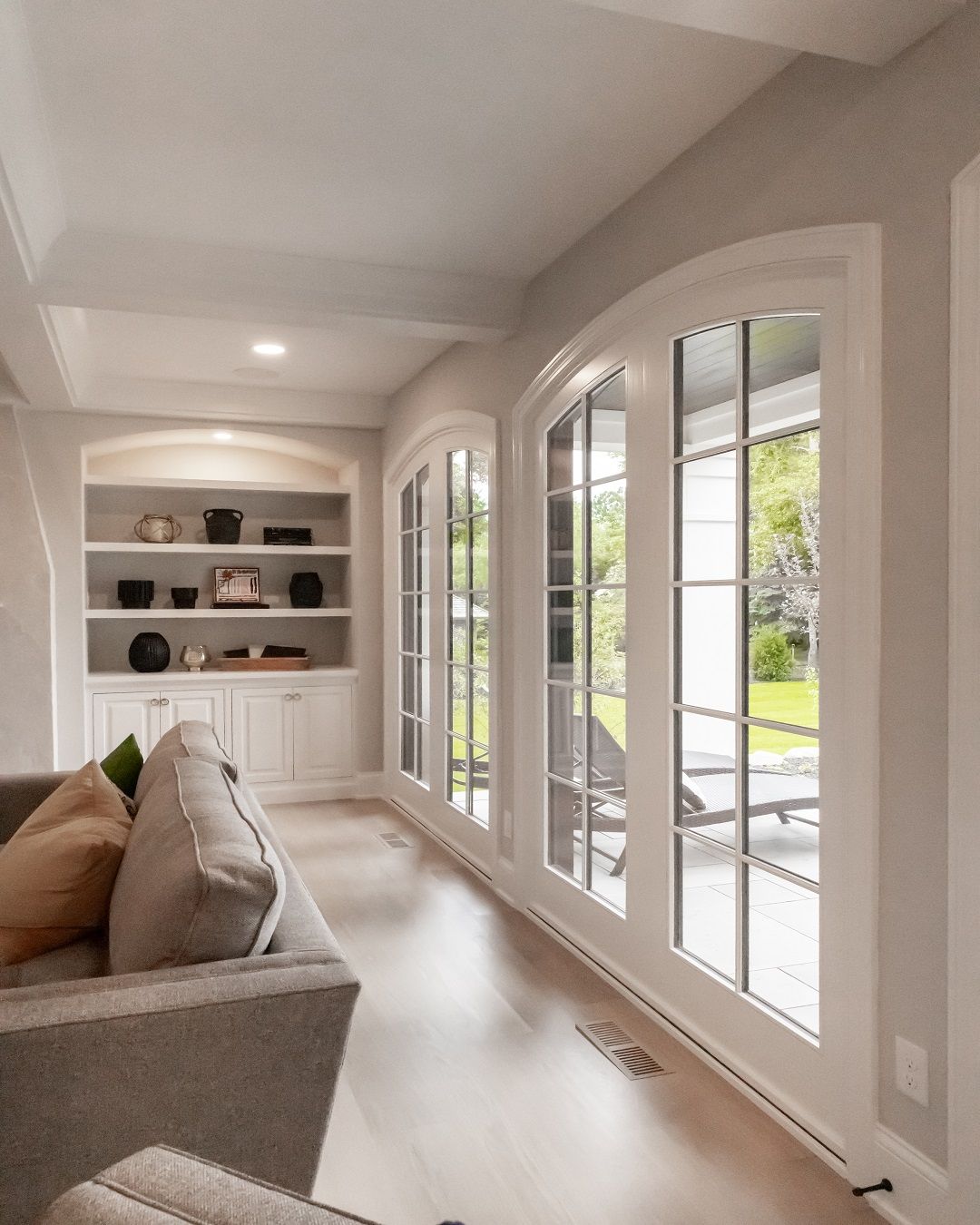 A living room with a couch and lots of windows