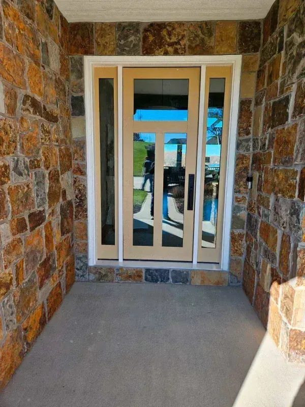 A stone wall with a wooden door in the middle