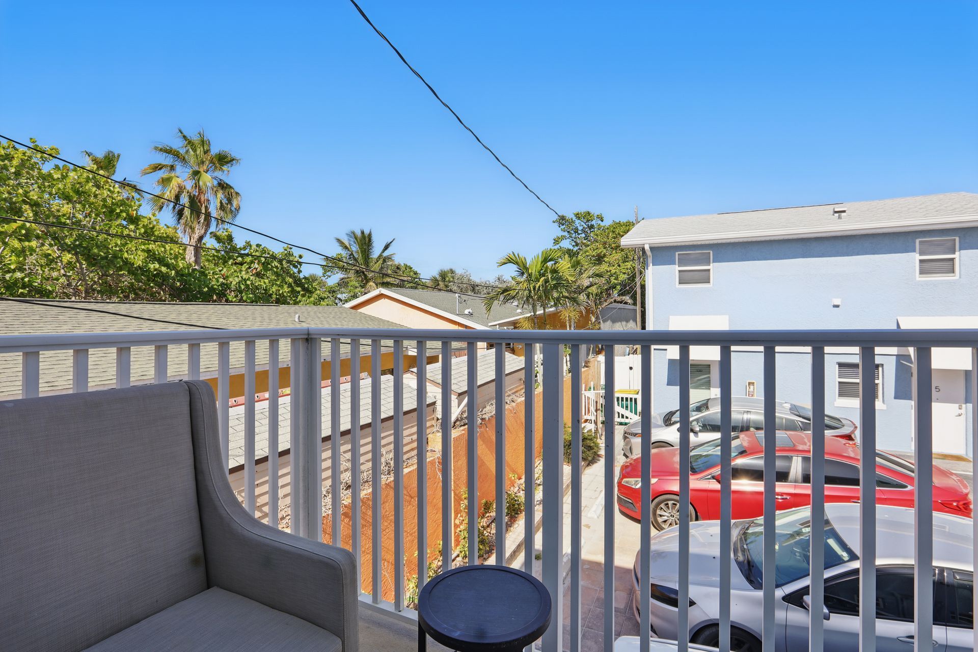 There is a balcony with a couch and a table on it.