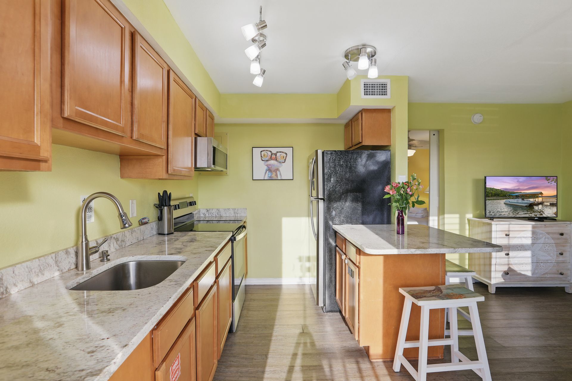 A kitchen with stainless steel appliances and granite counter tops