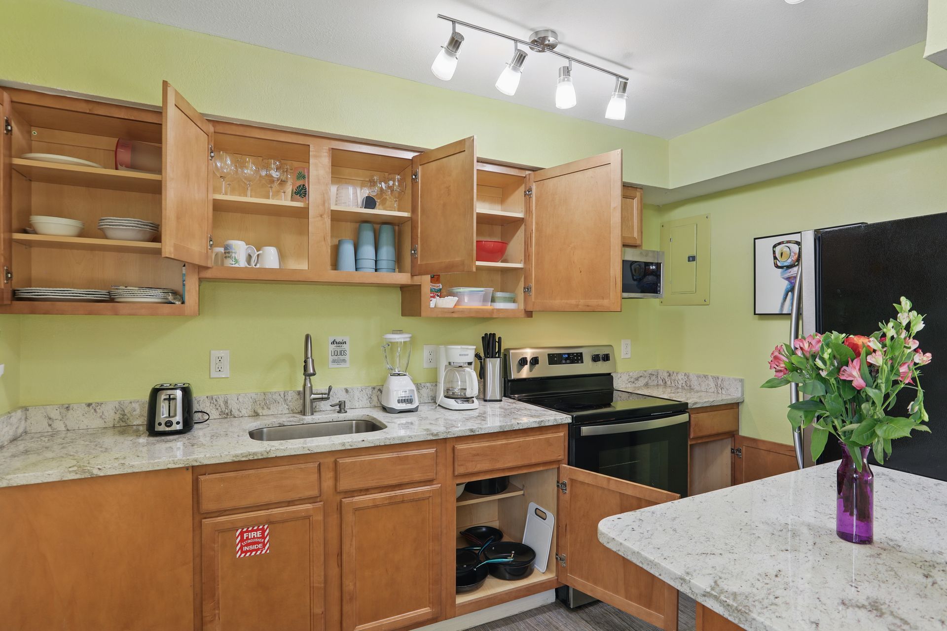 A kitchen with wooden cabinets and granite counter tops