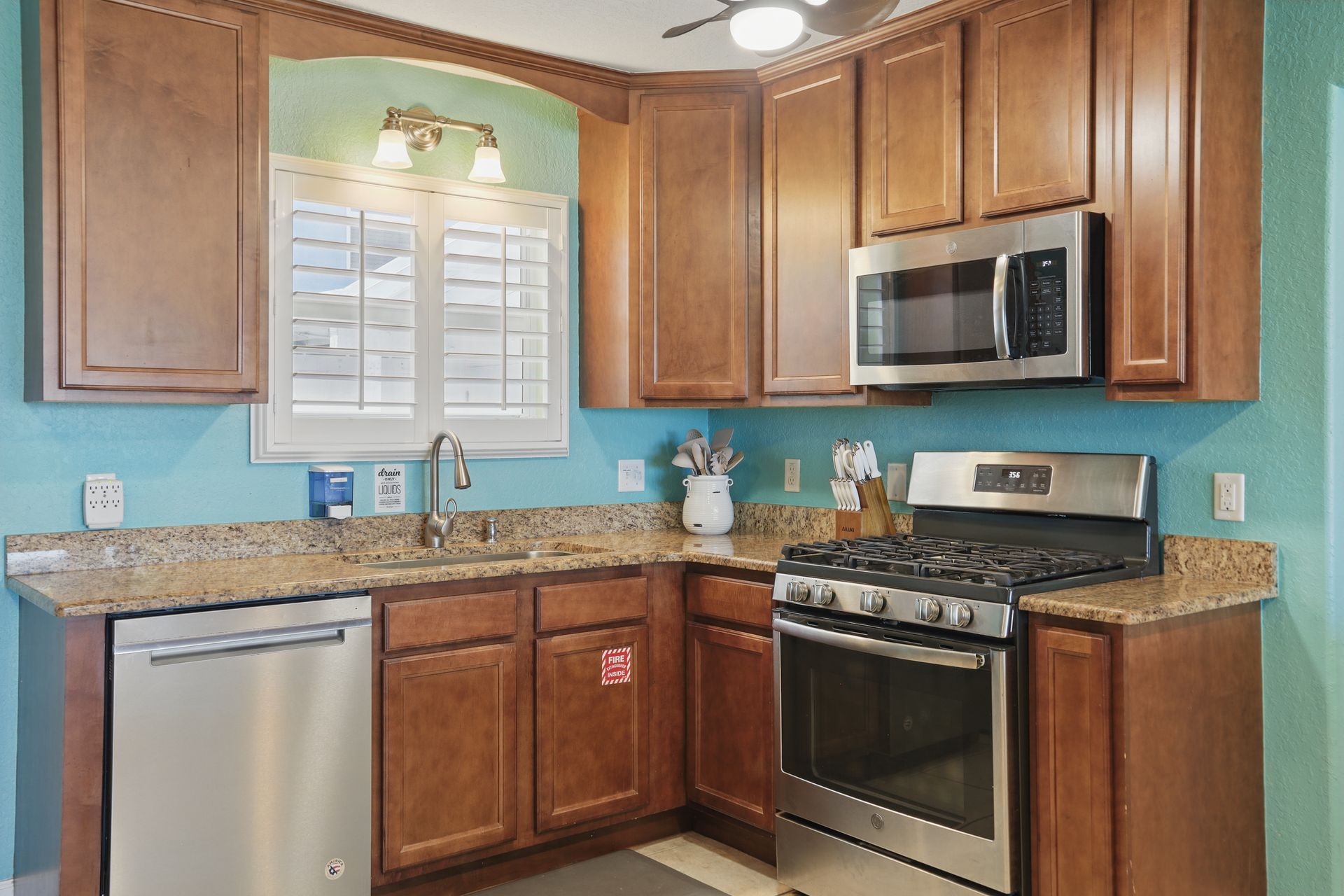 A kitchen with stainless steel appliances and wooden cabinets