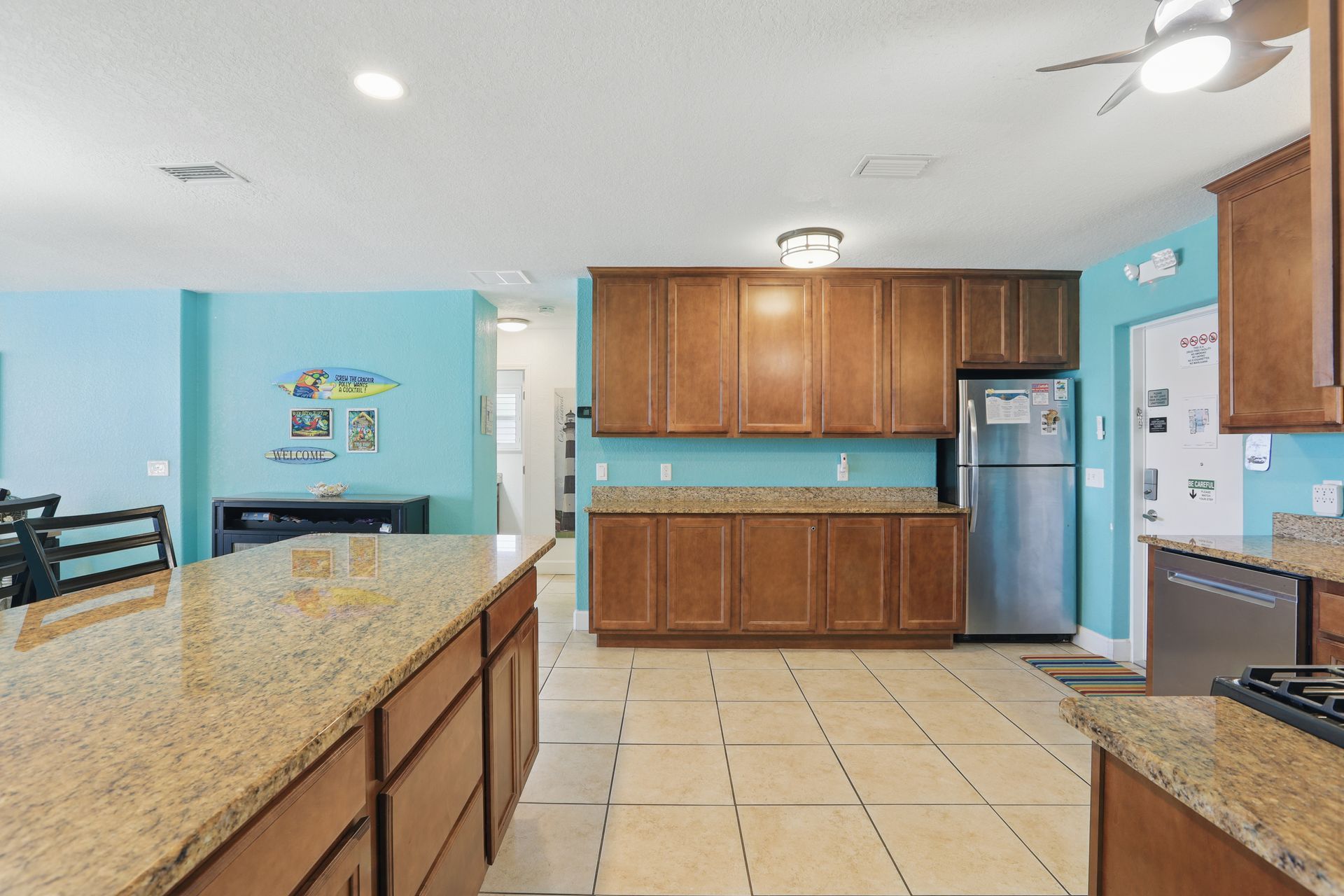A kitchen with stainless steel appliances , granite counter tops , and wooden cabinets.