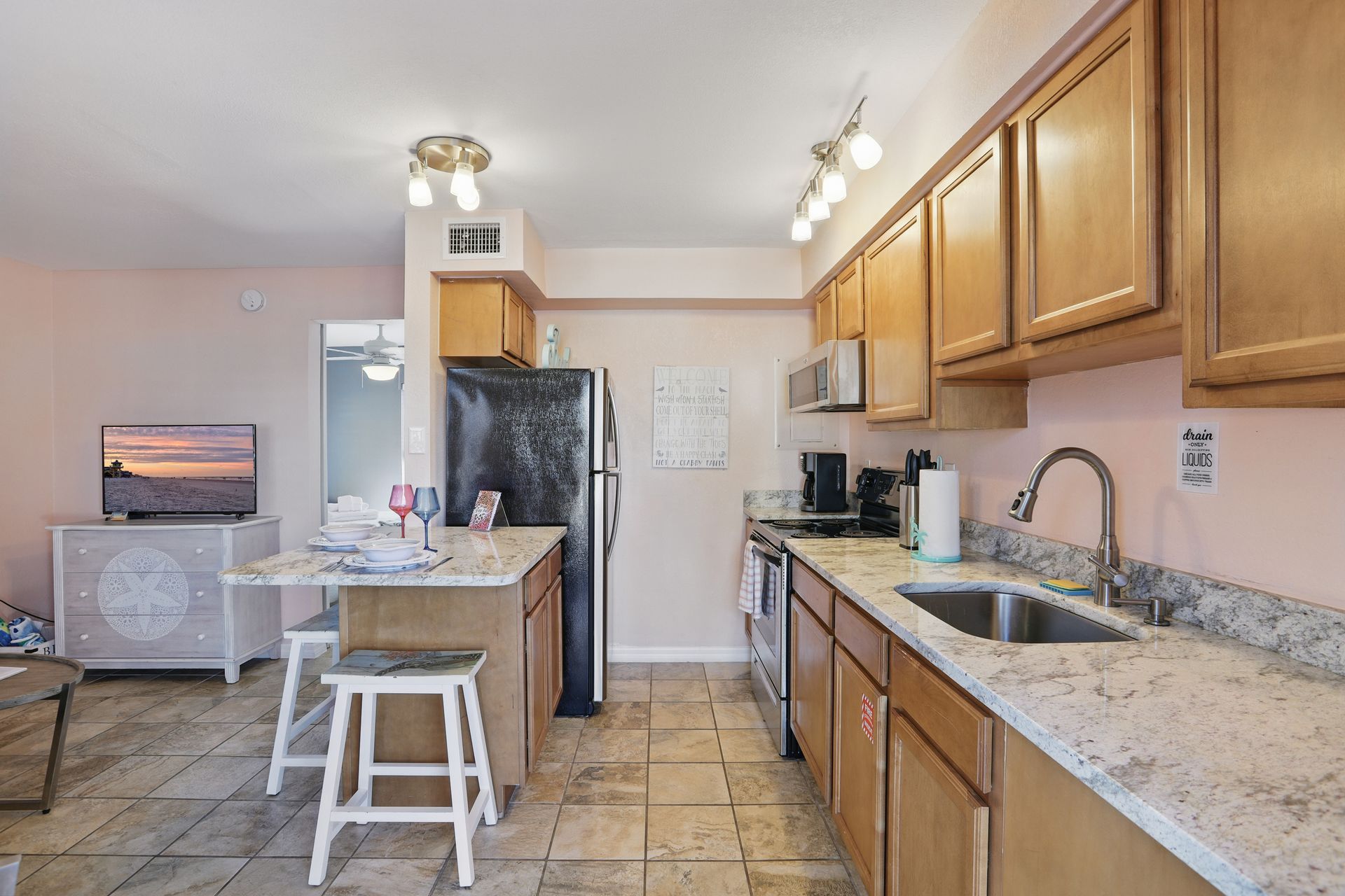 A kitchen with wooden cabinets and granite counter tops