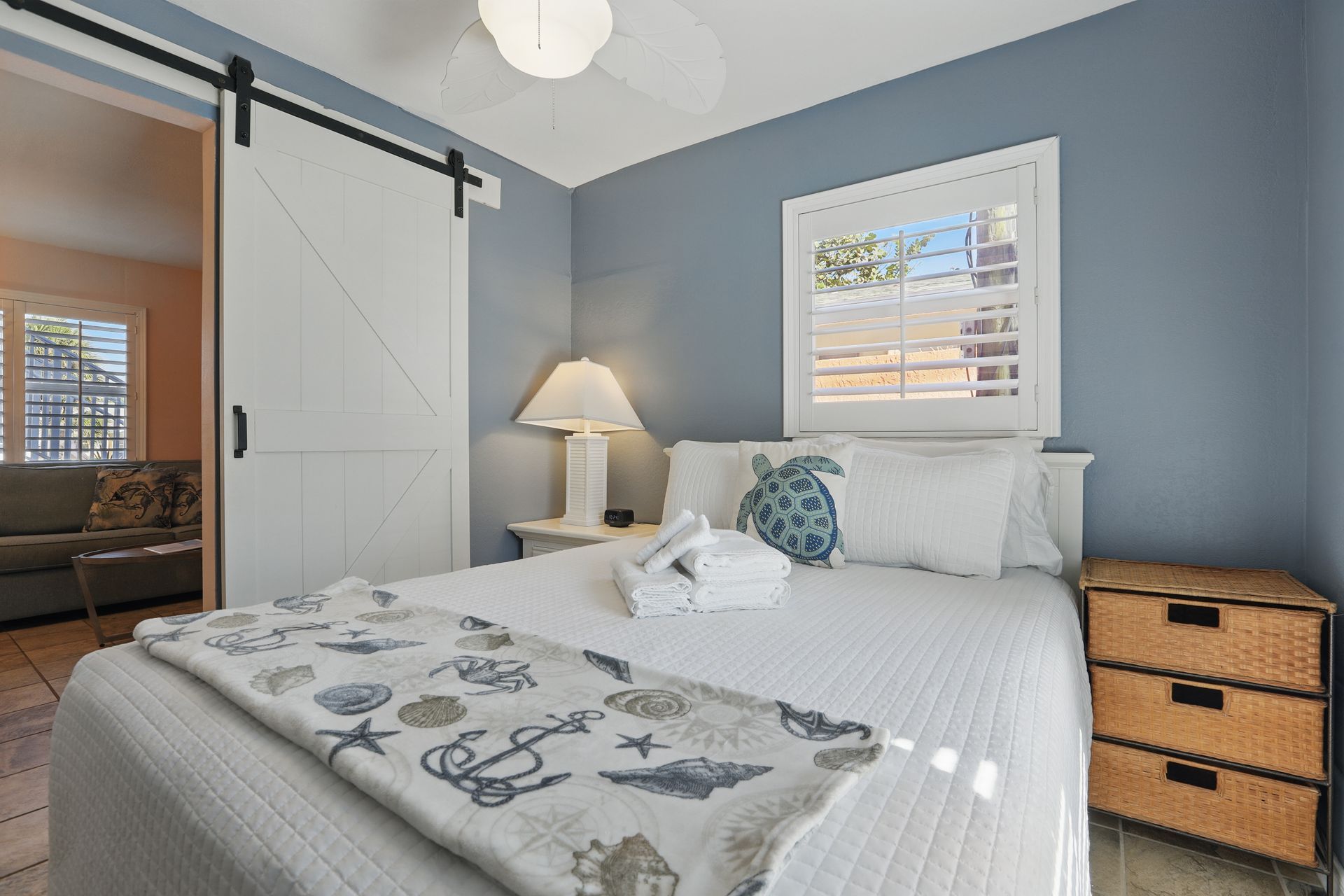 A bedroom with a king size bed and a sliding barn door.