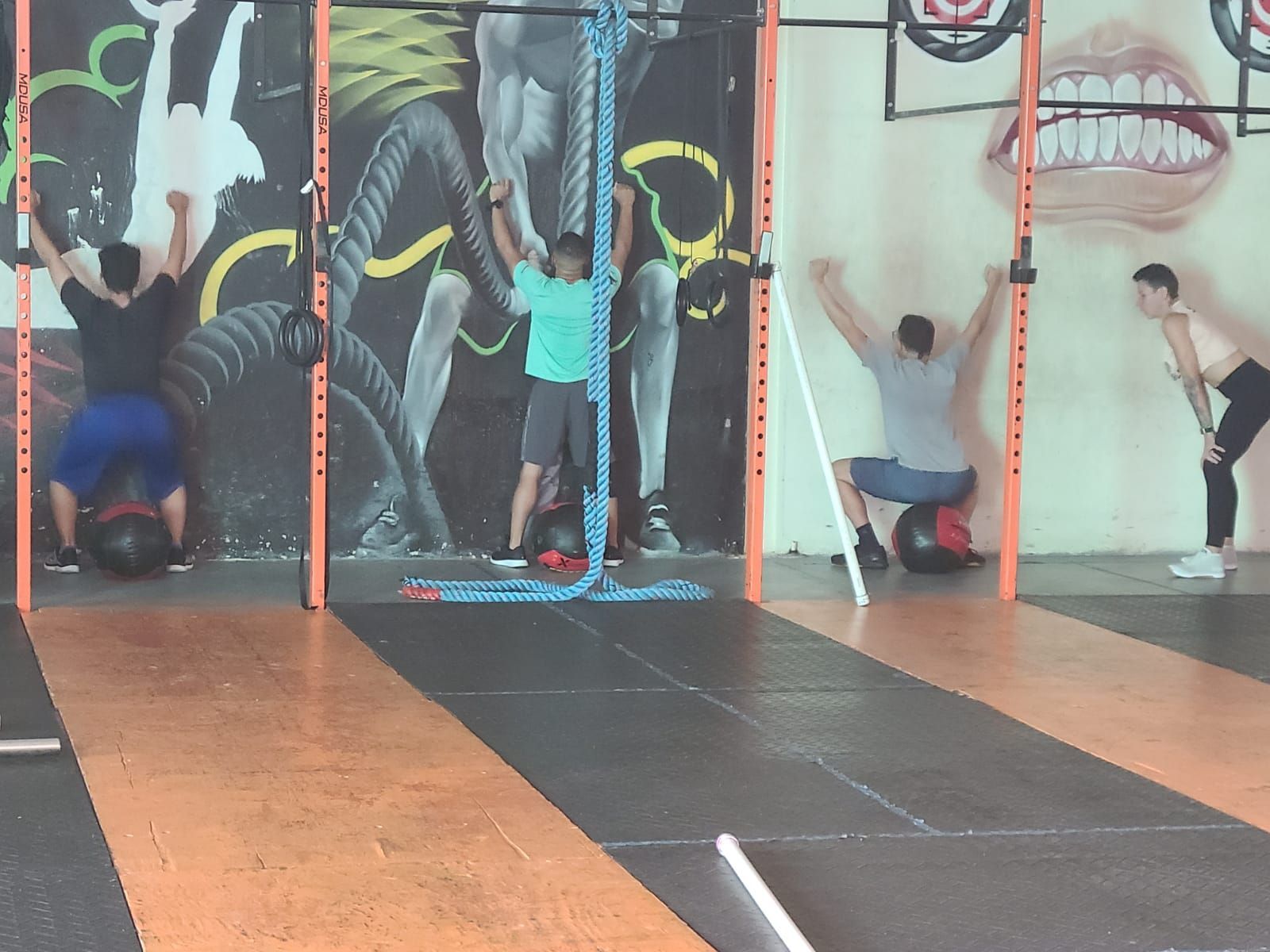 A group of people are doing exercises in a gym