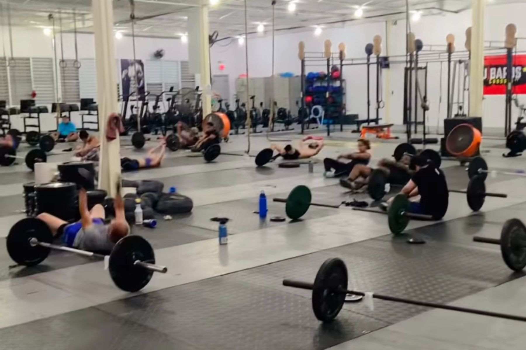 A group of people are doing exercises in a gym.