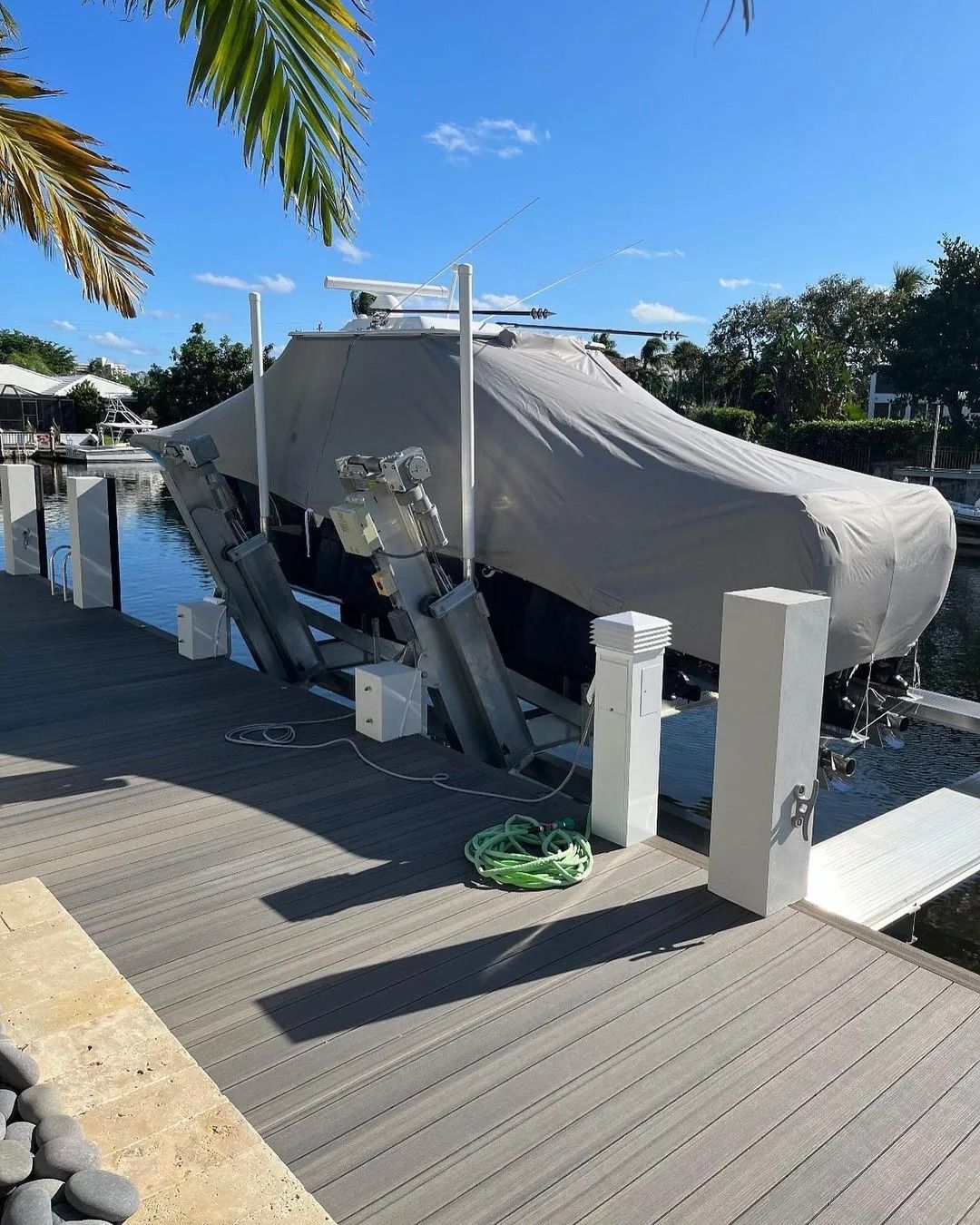 A boat is docked at a dock with a cover on it.