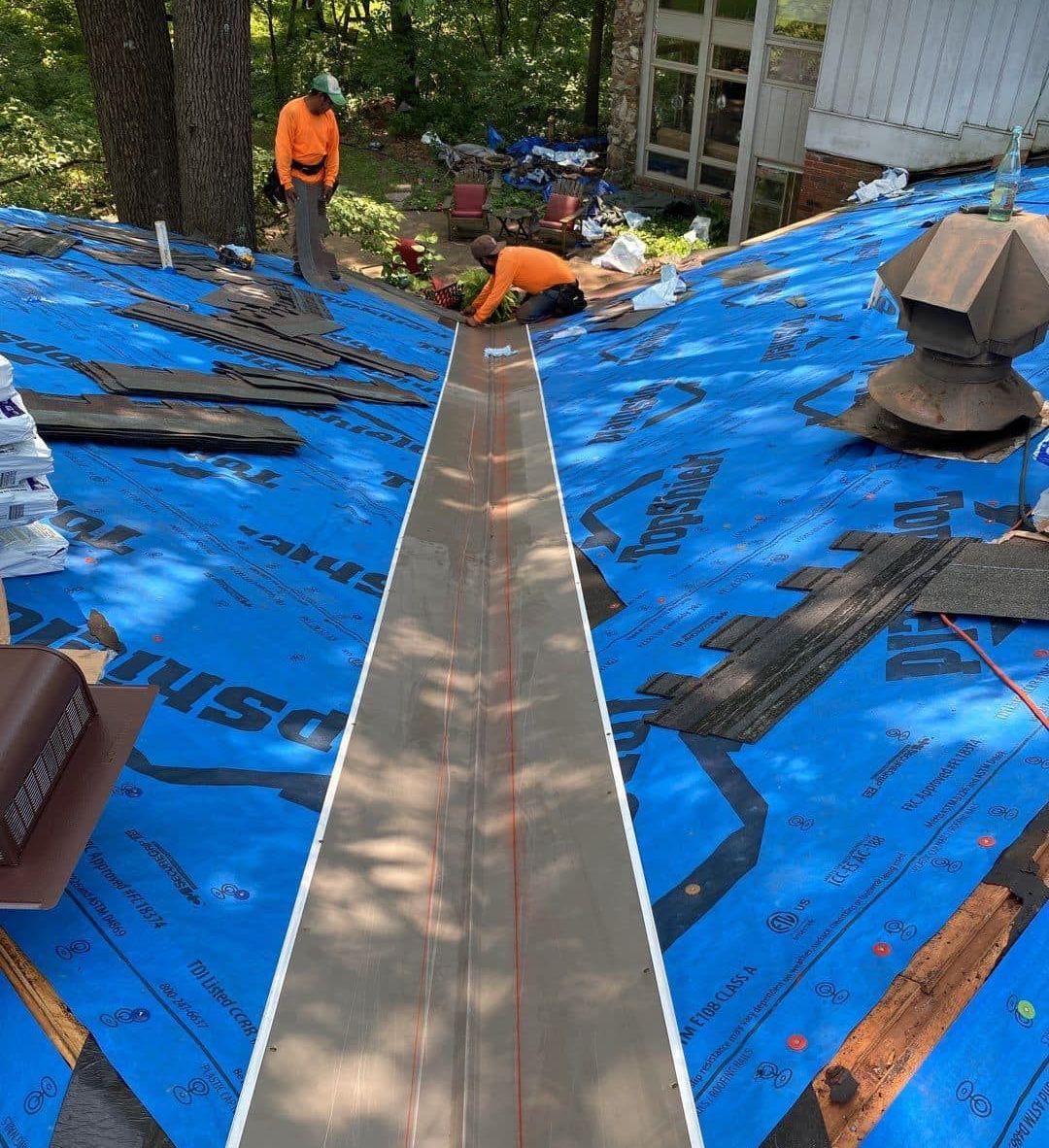 A group of people are working on a roof.