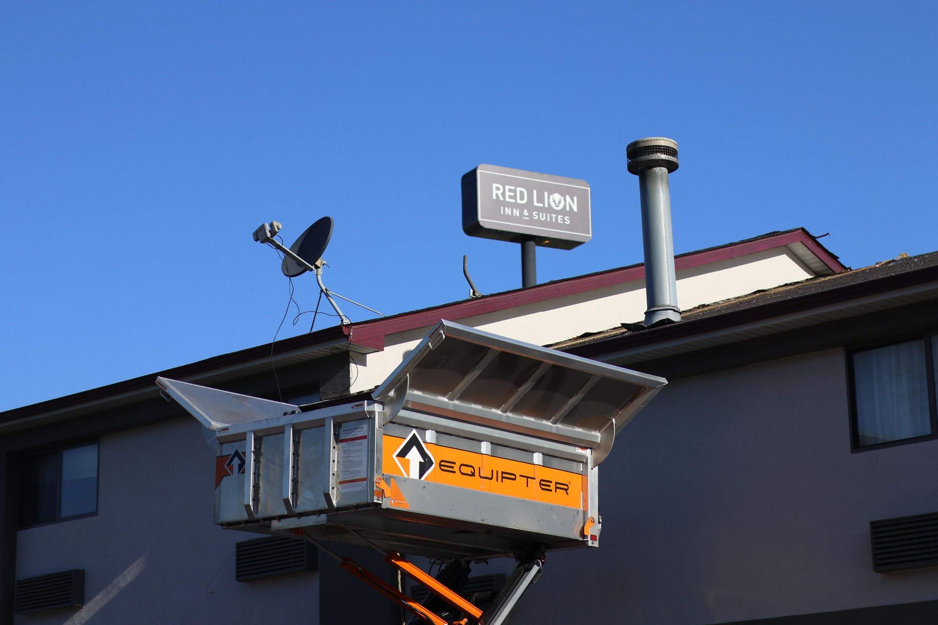 A man is applying a roof coating to a roof.