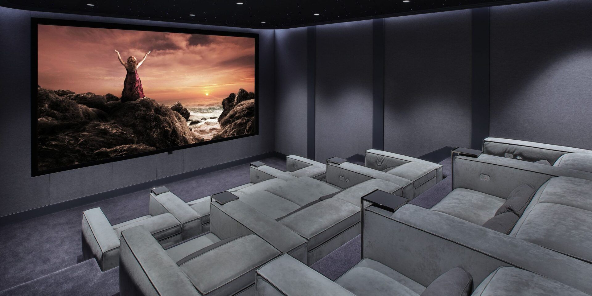 A home theater with a large screen and lots of seats