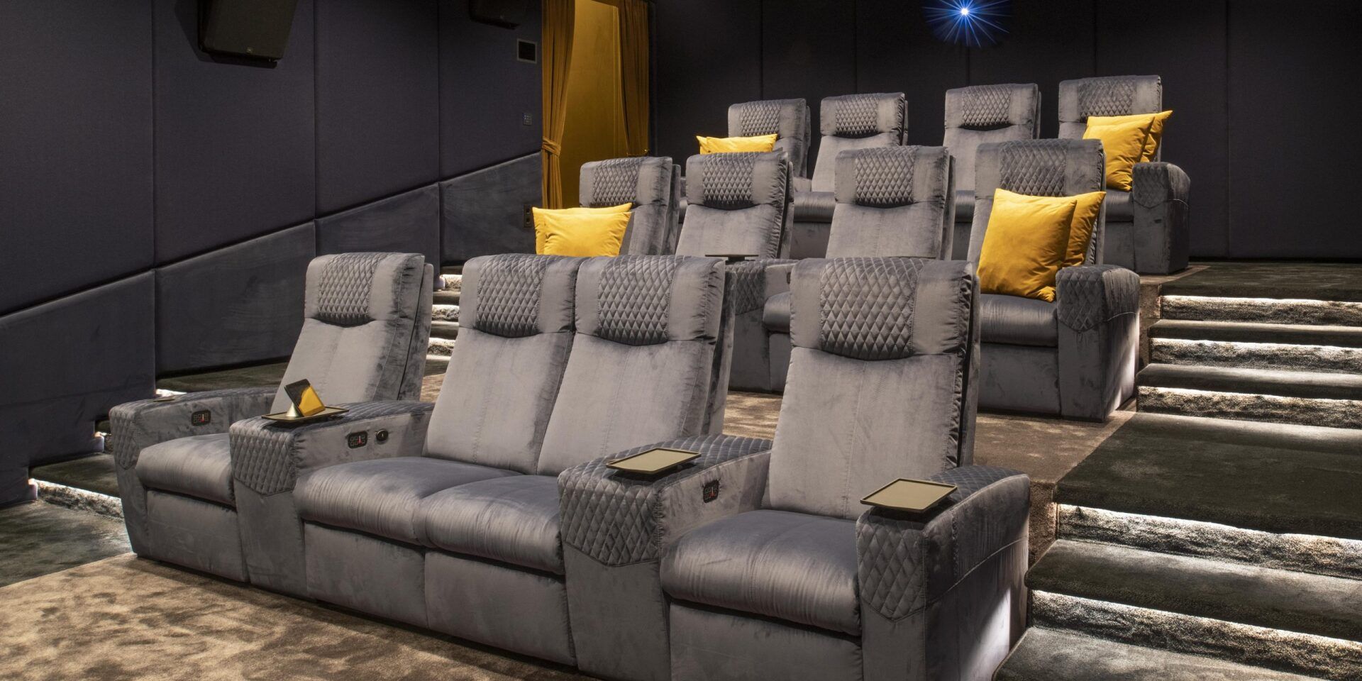 A movie theater with a lot of seats and a couch.