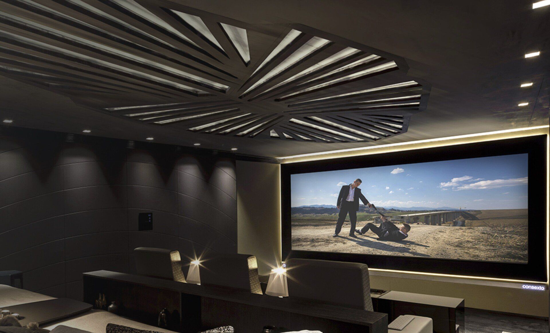 A home theater with a large screen and a ceiling fan.