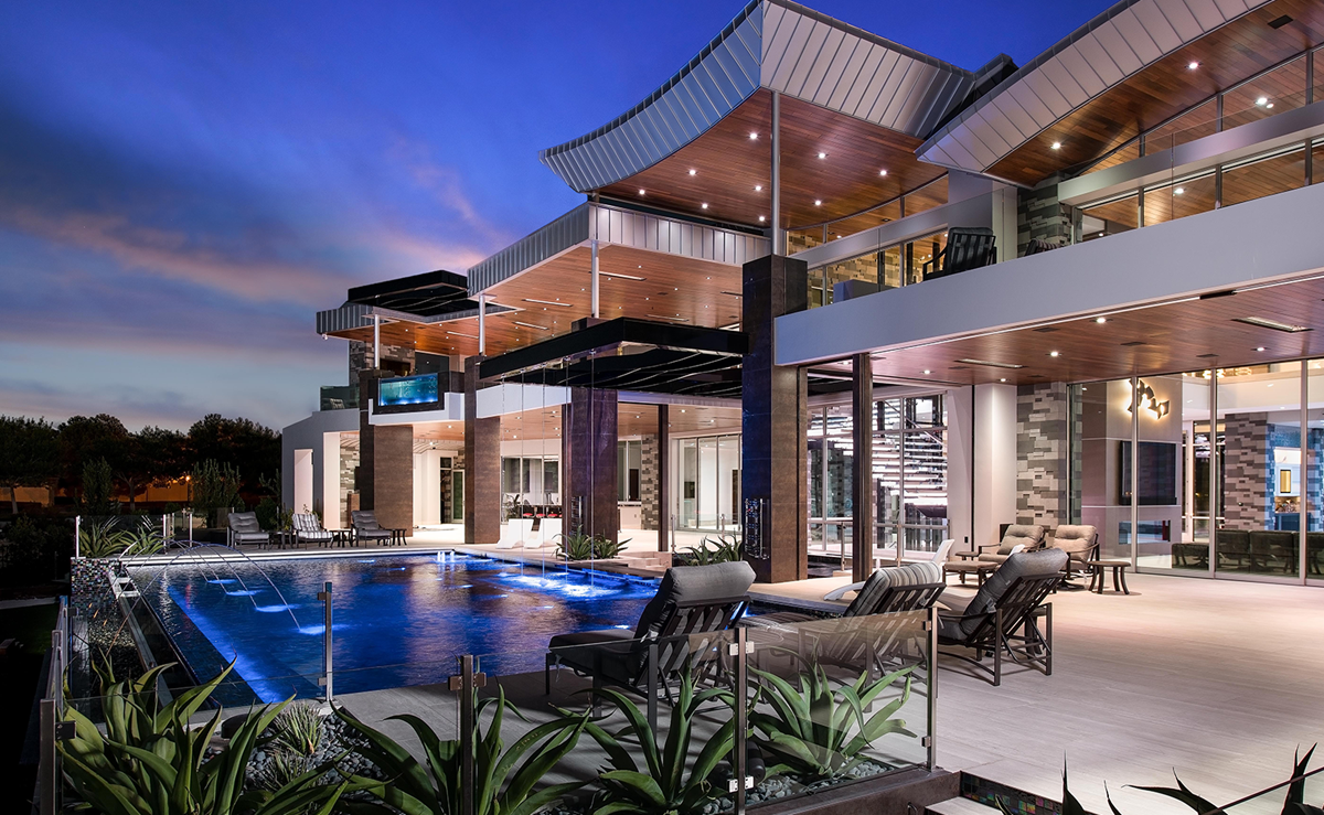 A large house with a swimming pool in front of it
