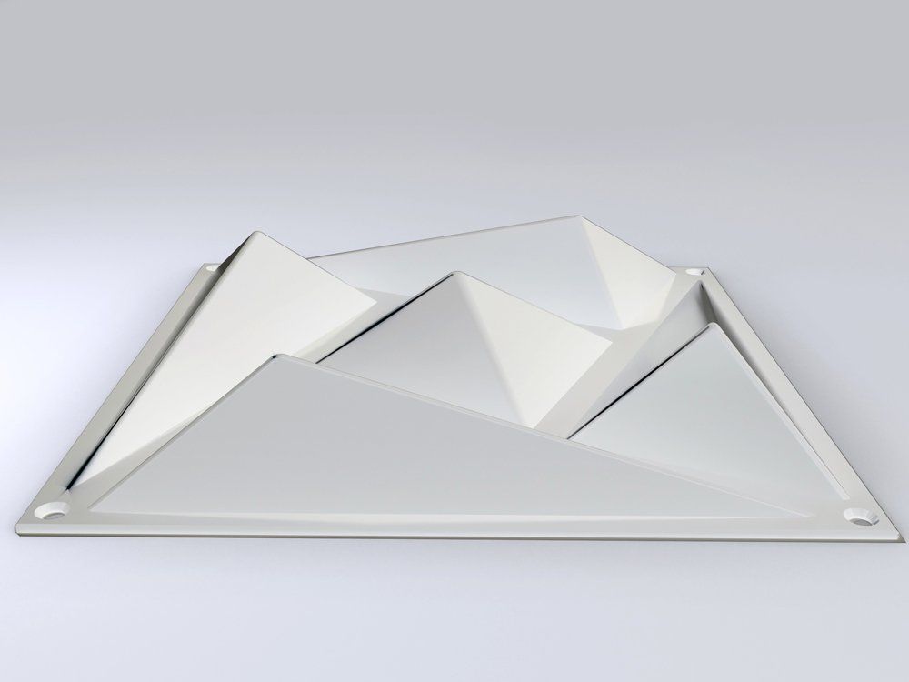 A white triangle shaped object is sitting on a white surface