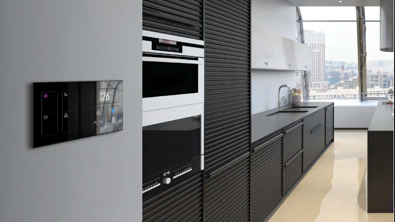 A kitchen with black cabinets , white appliances and a large window.