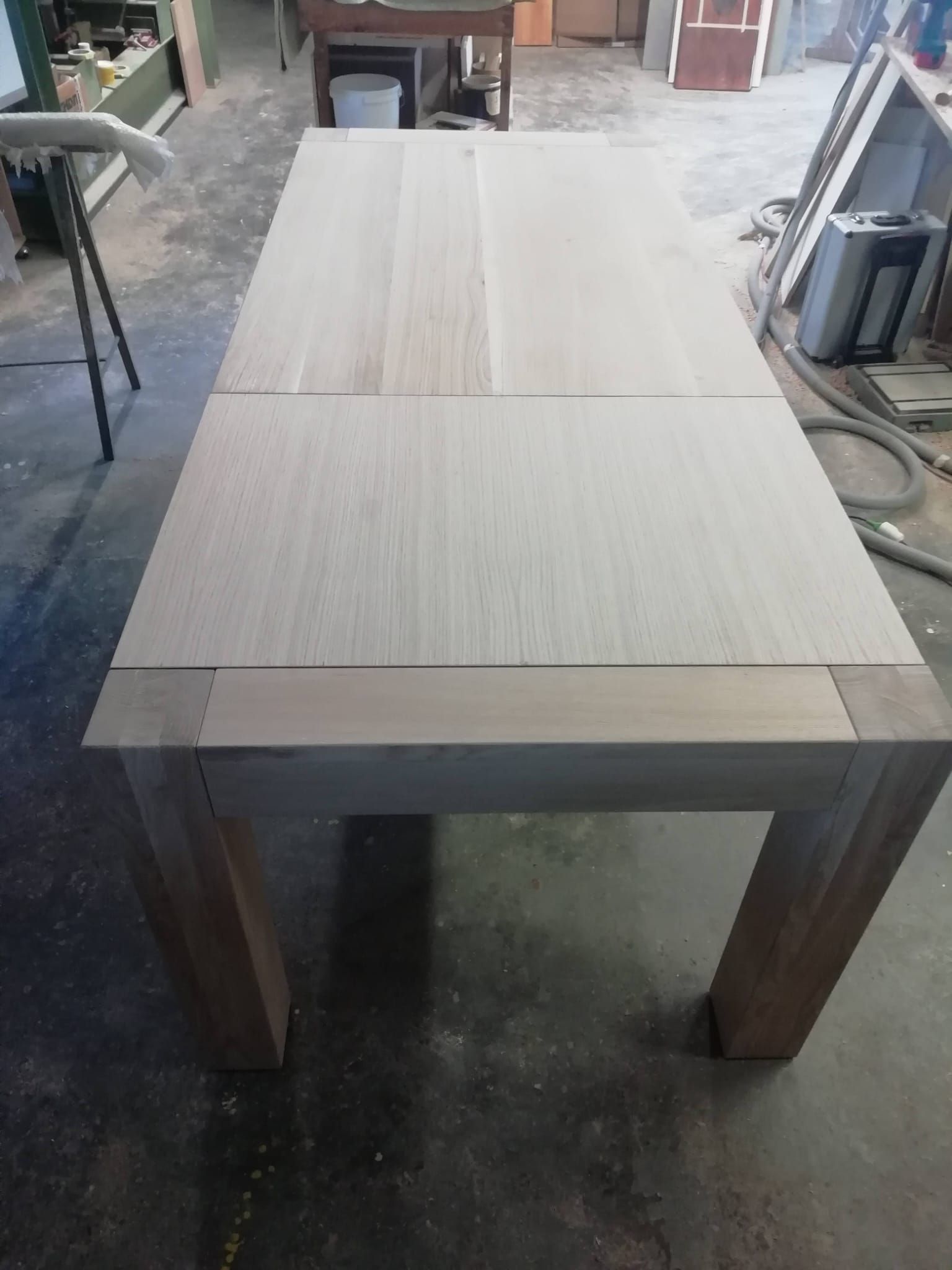 Sul pavimento di un laboratorio c'è un tavolo di legno.