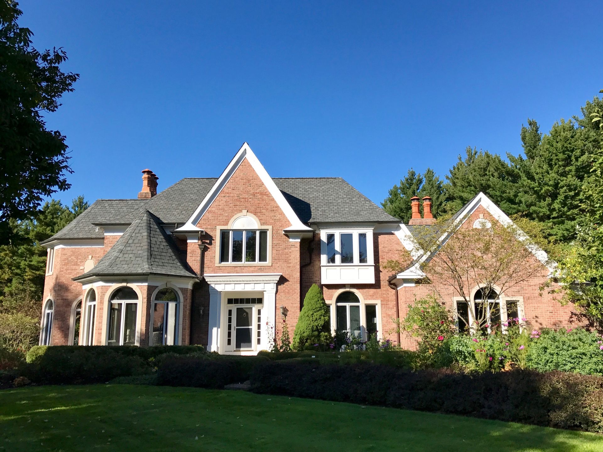 a large blue house with a gray roof and a white garage door .