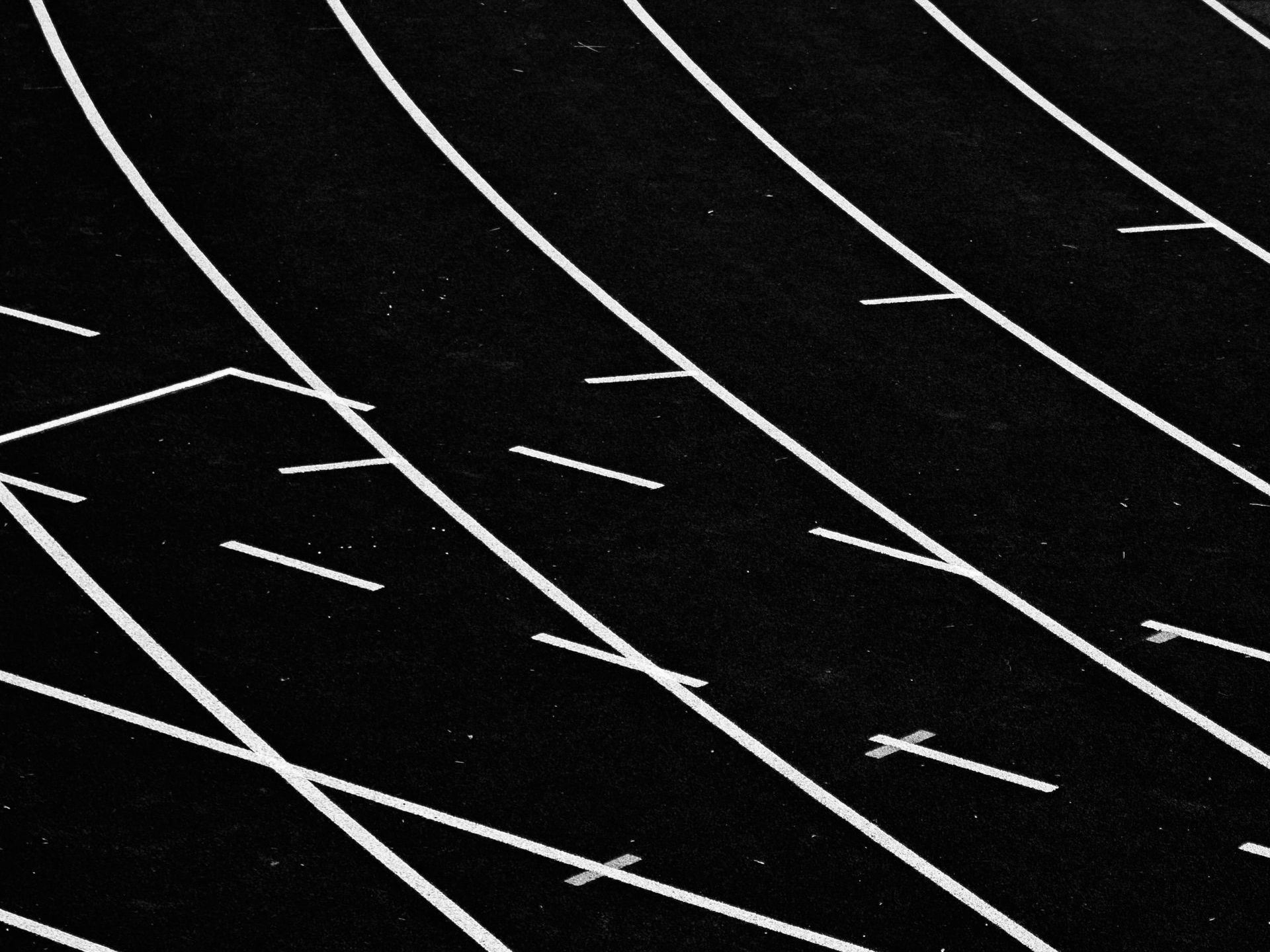 a black track with white lines and crosses on it