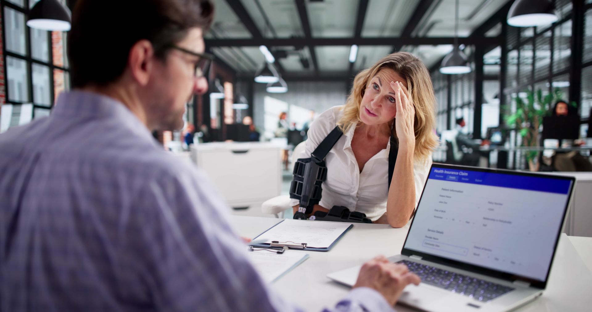 Social security attorney consulting with disability claimant during benefits case review. Social security attorney consulting with disability claimant during benefits case review.