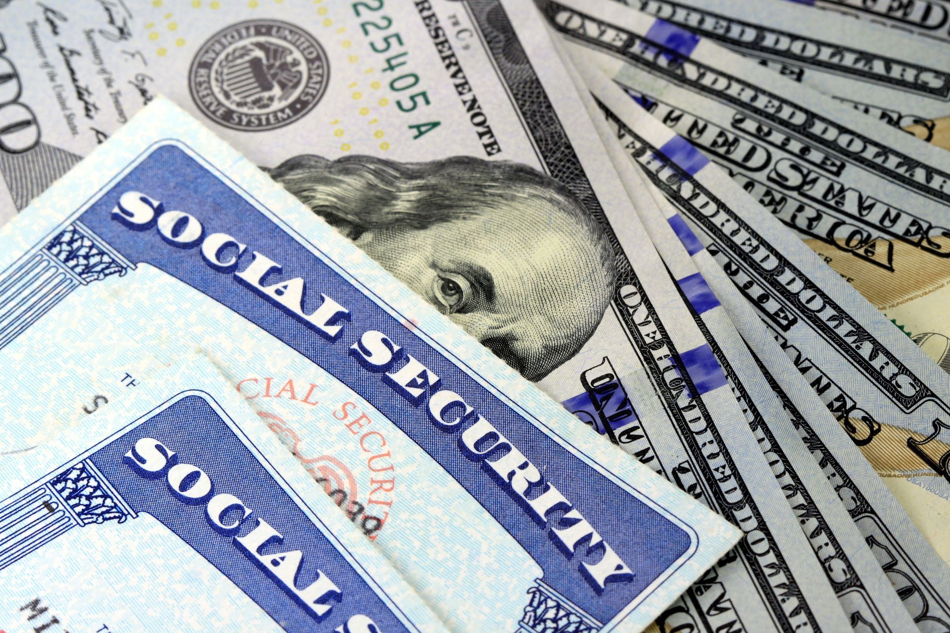 Social Security cards on top of U.S. dollar bills