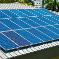 Blue solar panels on a rooftop in bright daylight