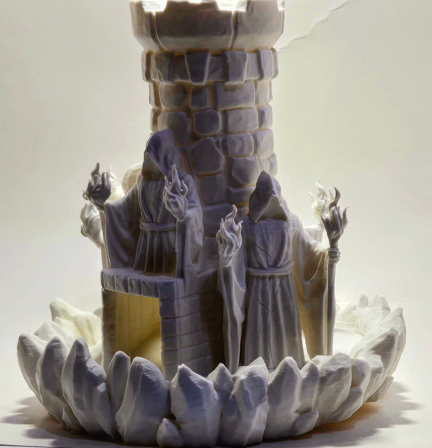 A statue of a man sitting in front of a tower