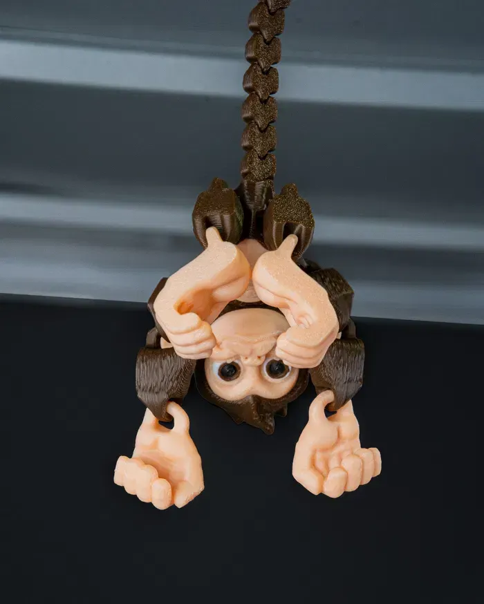 A toy monkey is sitting on a black surface
