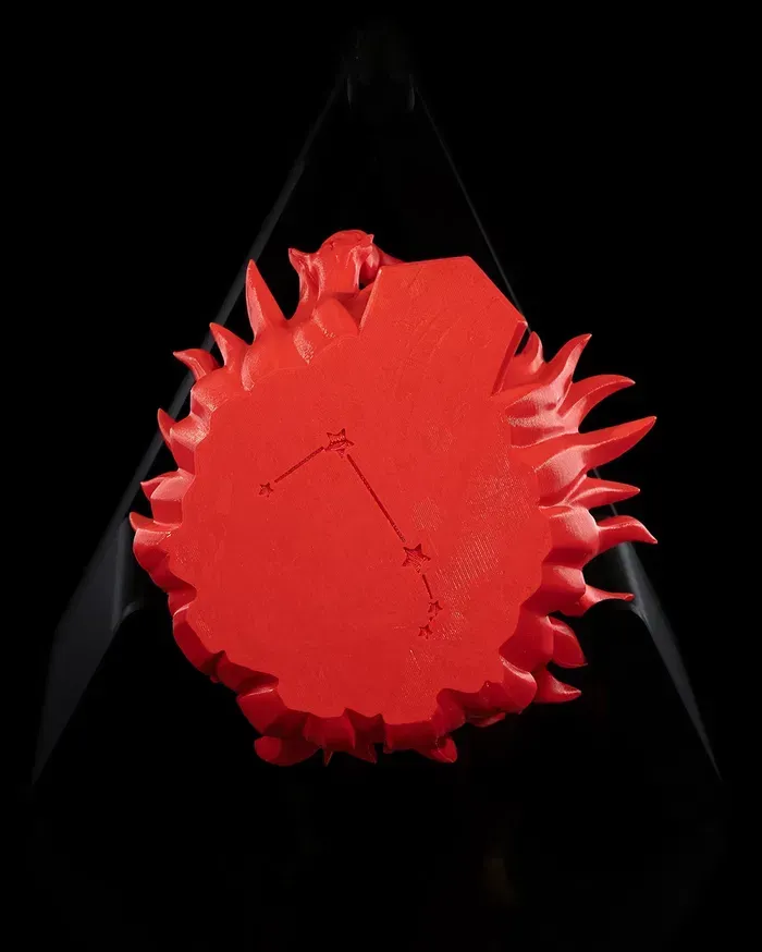 A red statue of a goat with horns on a black background.