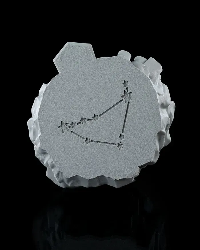 A statue of a goat sitting on top of a rock.