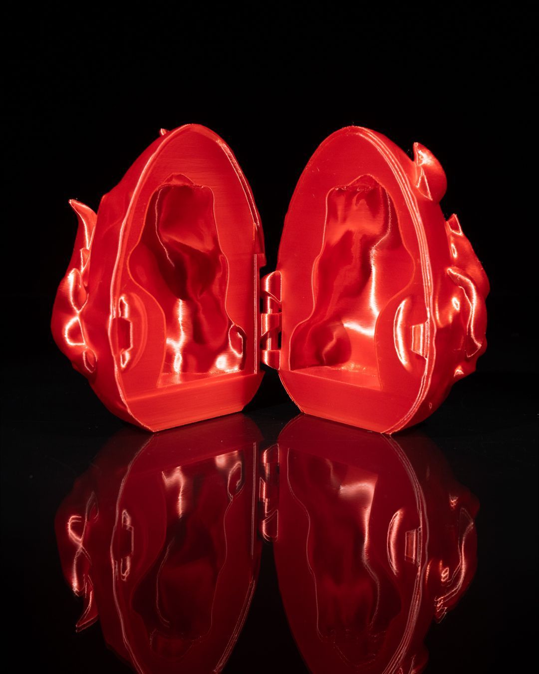 A red egg with a dragon inside of it