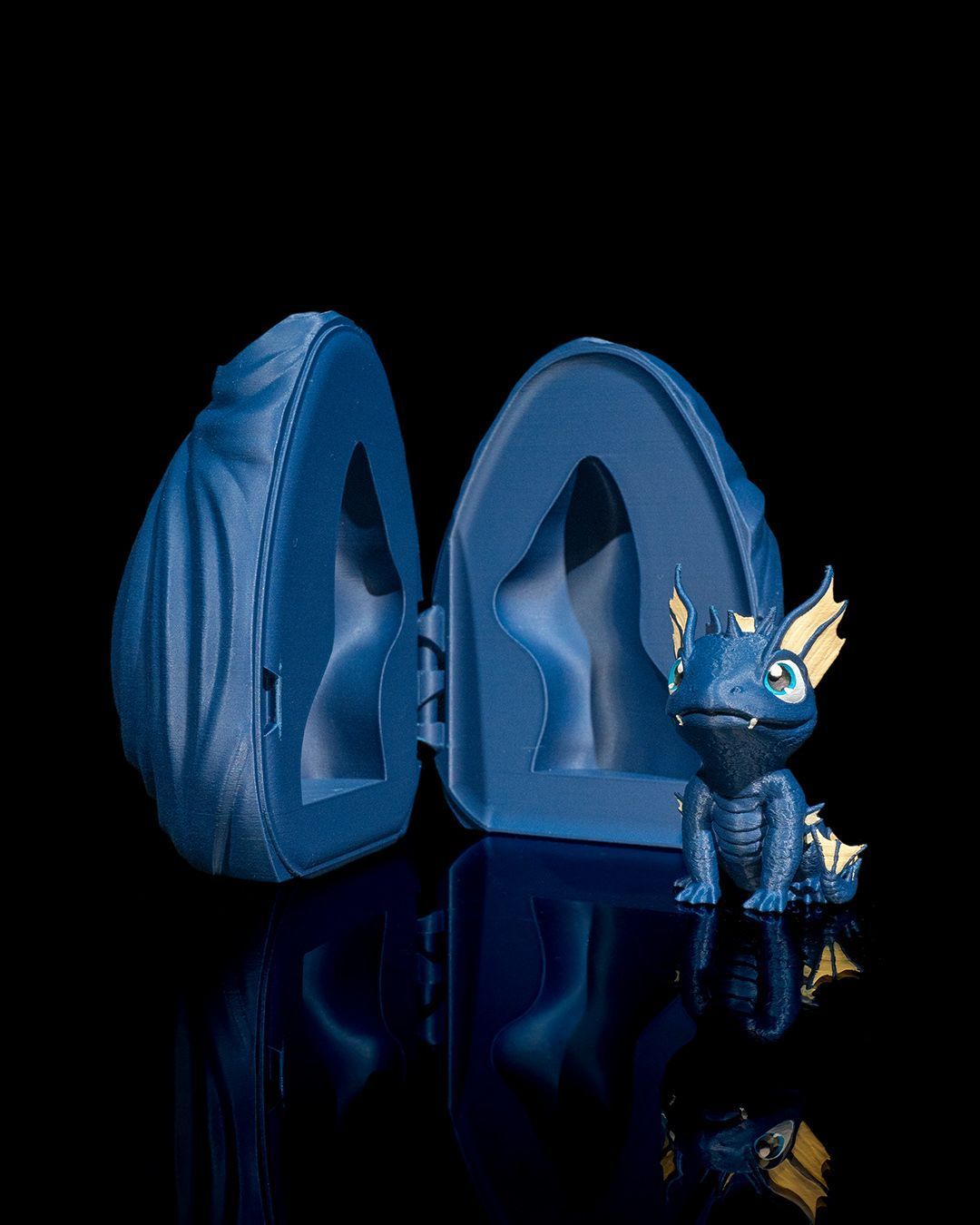 A blue dragon figurine is sitting next to a blue squirrel figurine.