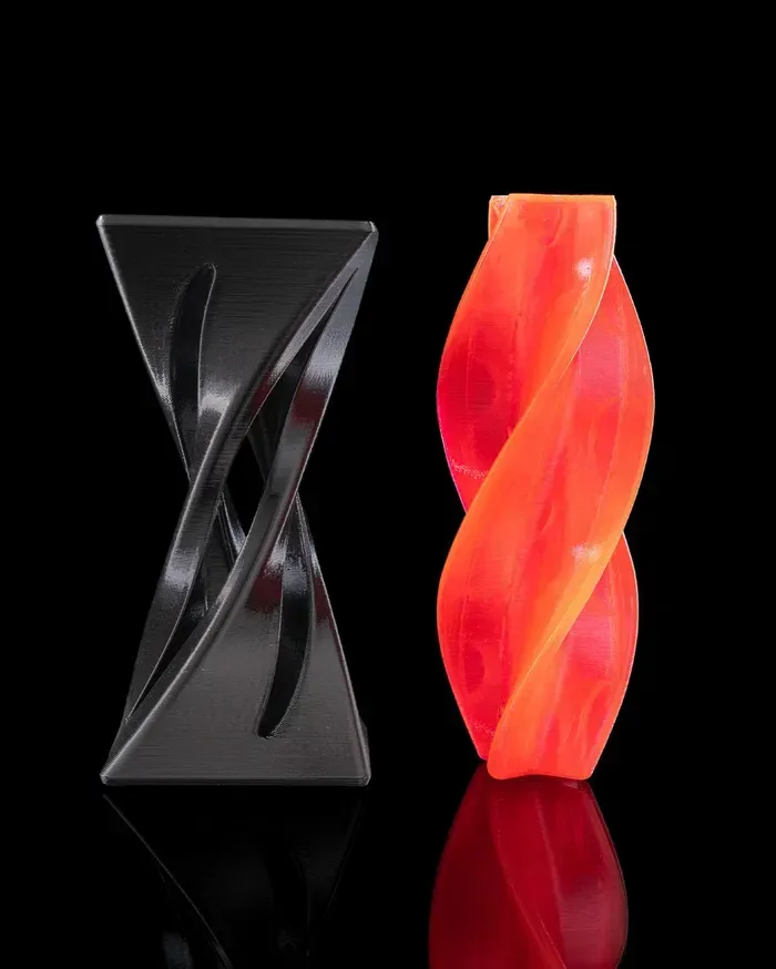 A red and black object is sitting on a black surface.