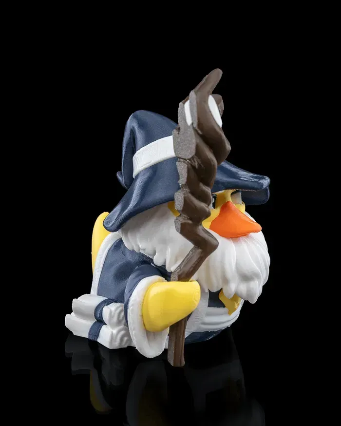 A rubber duck with a beard and hat is holding a cane.