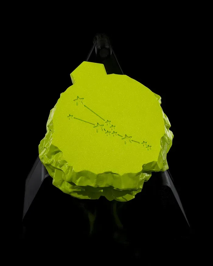 A green statue of a bull with a taurus symbol on it