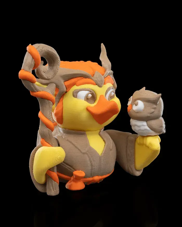 A figurine of an owl holding a stick and a bird.